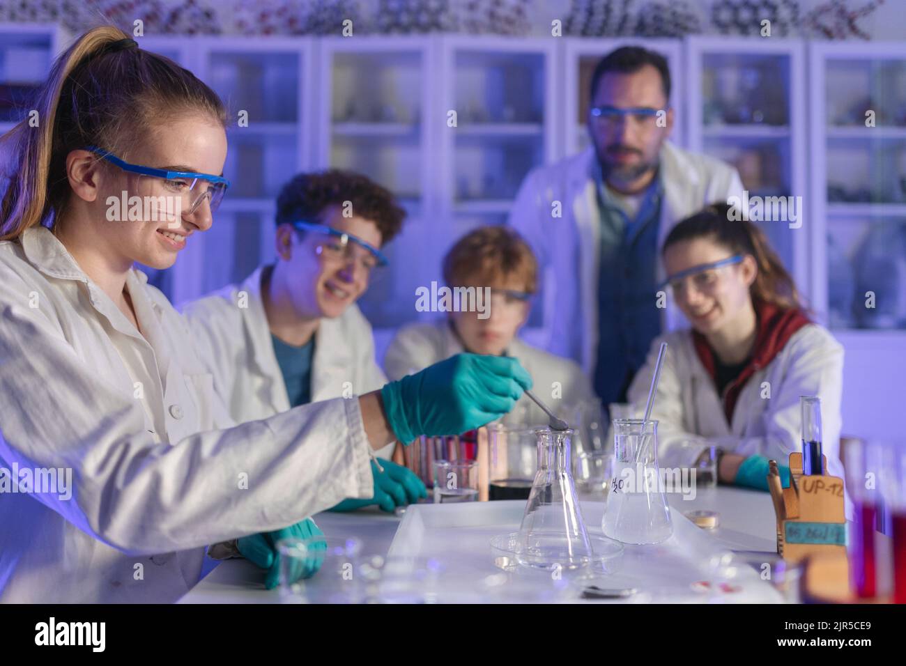 Excited Science Students With Teacher Doing Chemical Experiment In The ...