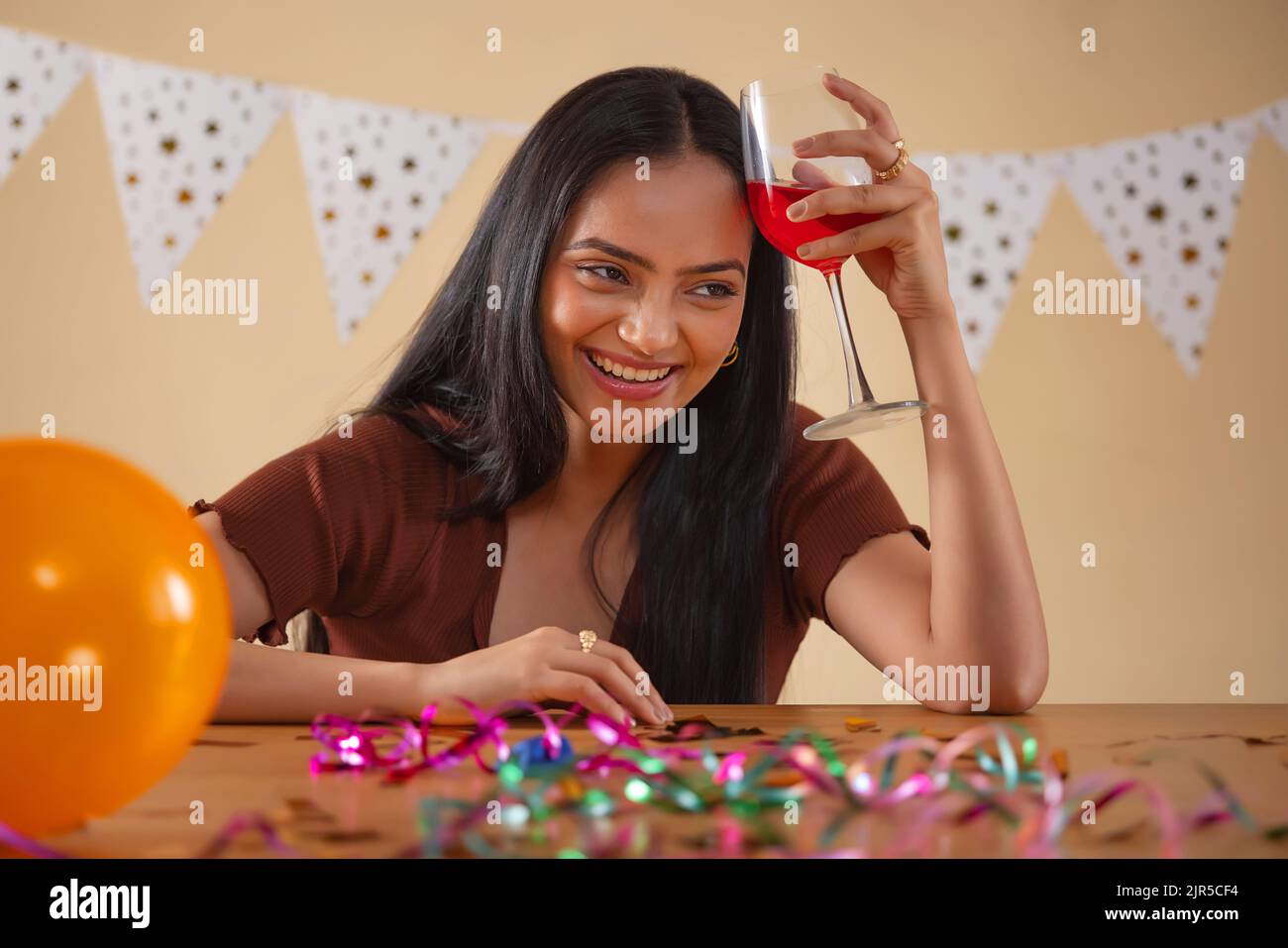 Portrait of young woman celebrating with a glass of wine Stock Photo