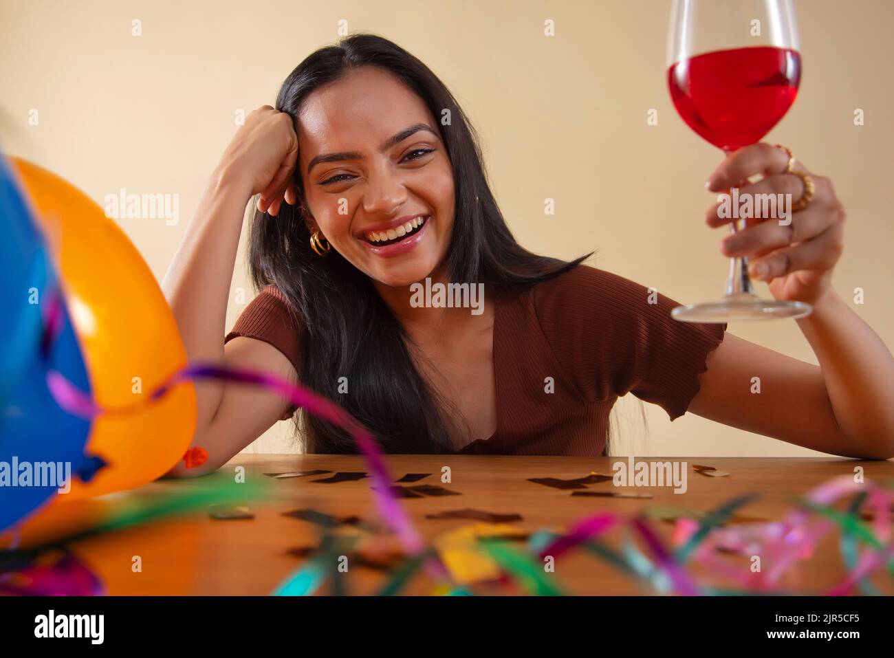 Portrait of young woman celebrating with a glass of wine Stock Photo
