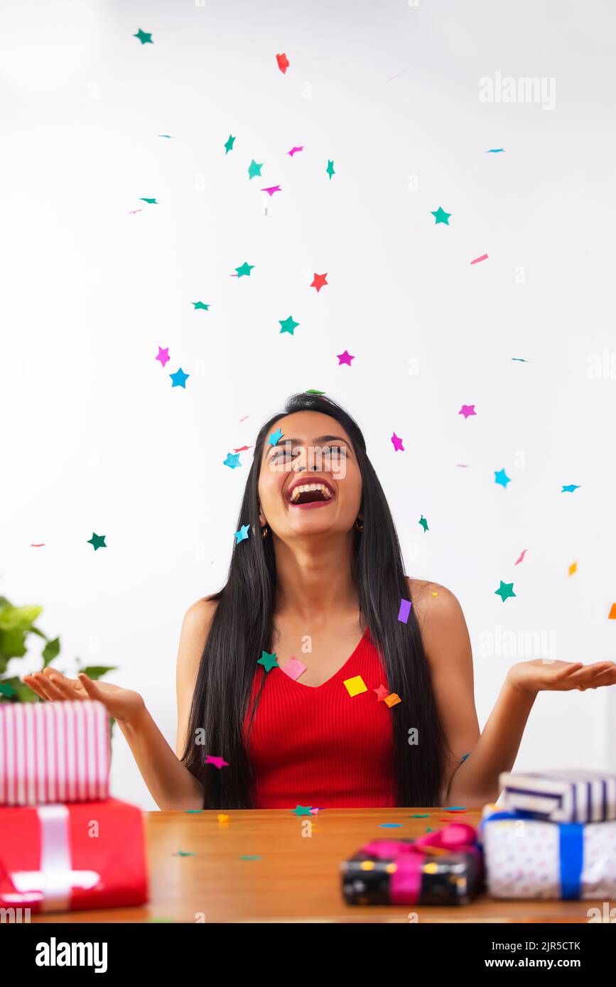 Cheerful young woman celebrating her birthday at home Stock Photo