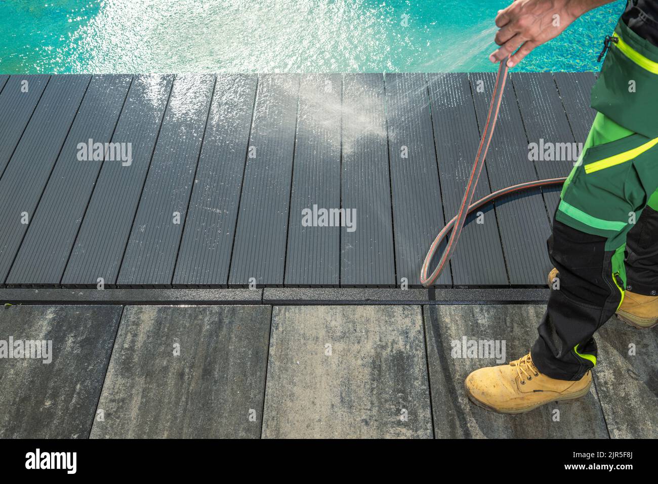 Men Pressure Washing Outdoor Swimming Pool Composite Deck. Pool