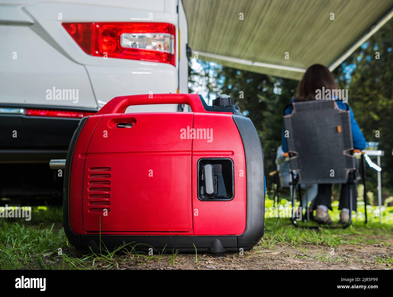Portable Gasoline Inverted Generator Staying Next to Camper Van Class C