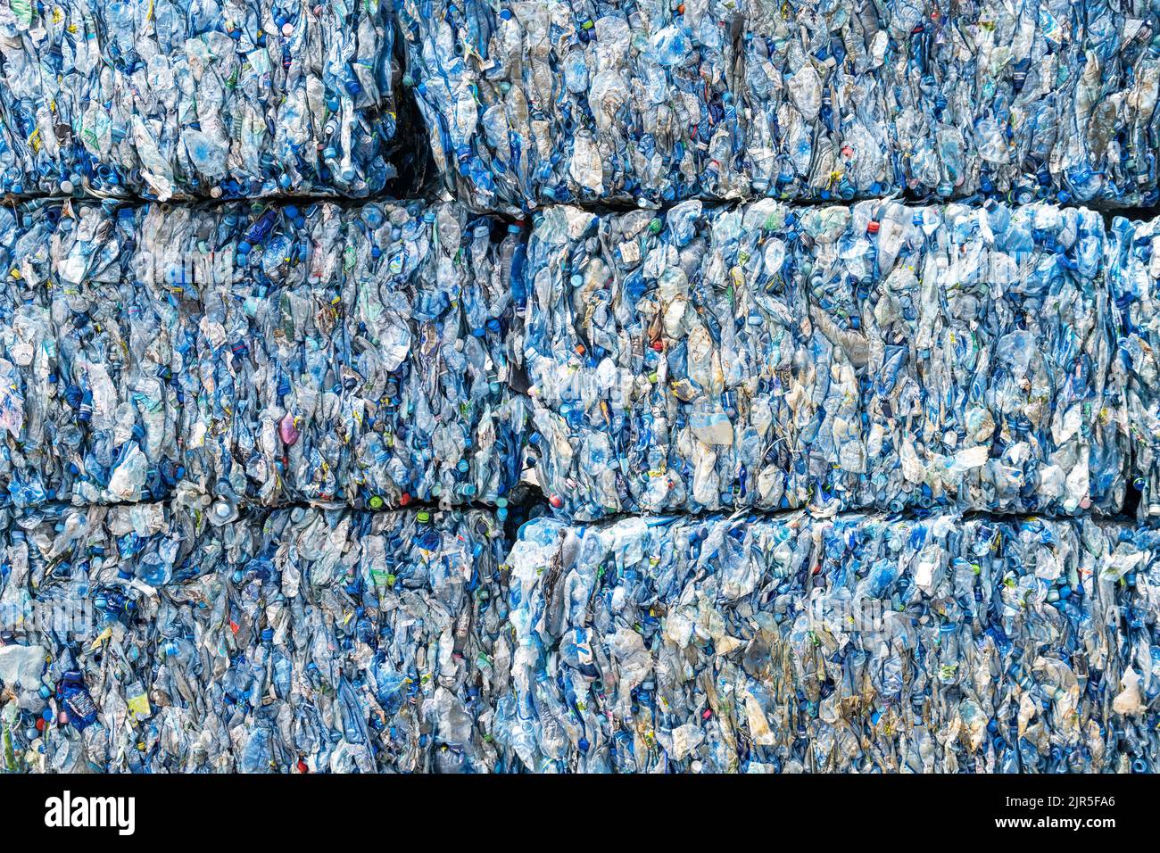 Huge Pile of Pressed PET Bottles Ready For Recycling Process. Urban Waste Management Theme. Stock Photo
