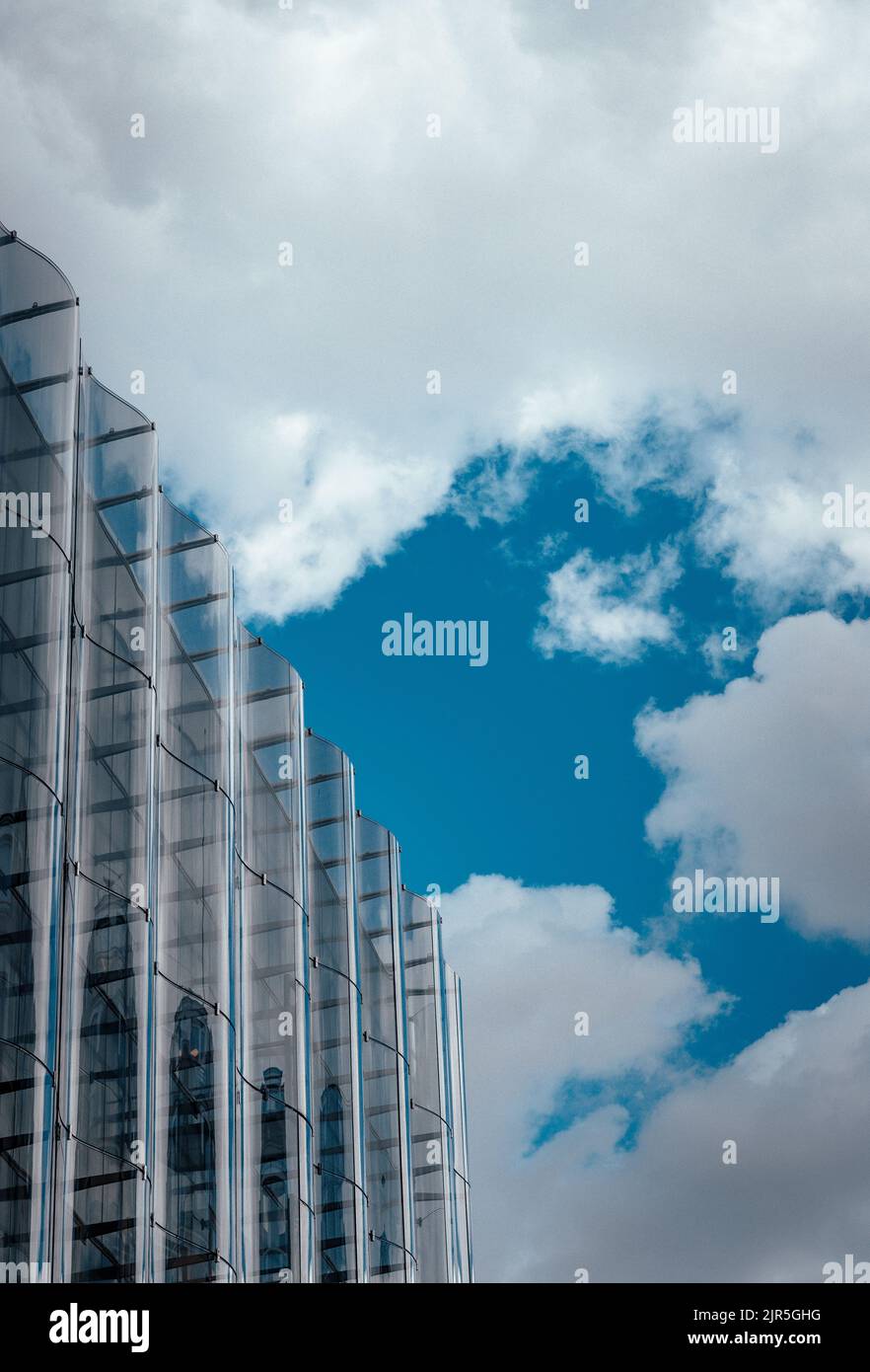 Building with blue sky and clouds Stock Photo - Alamy