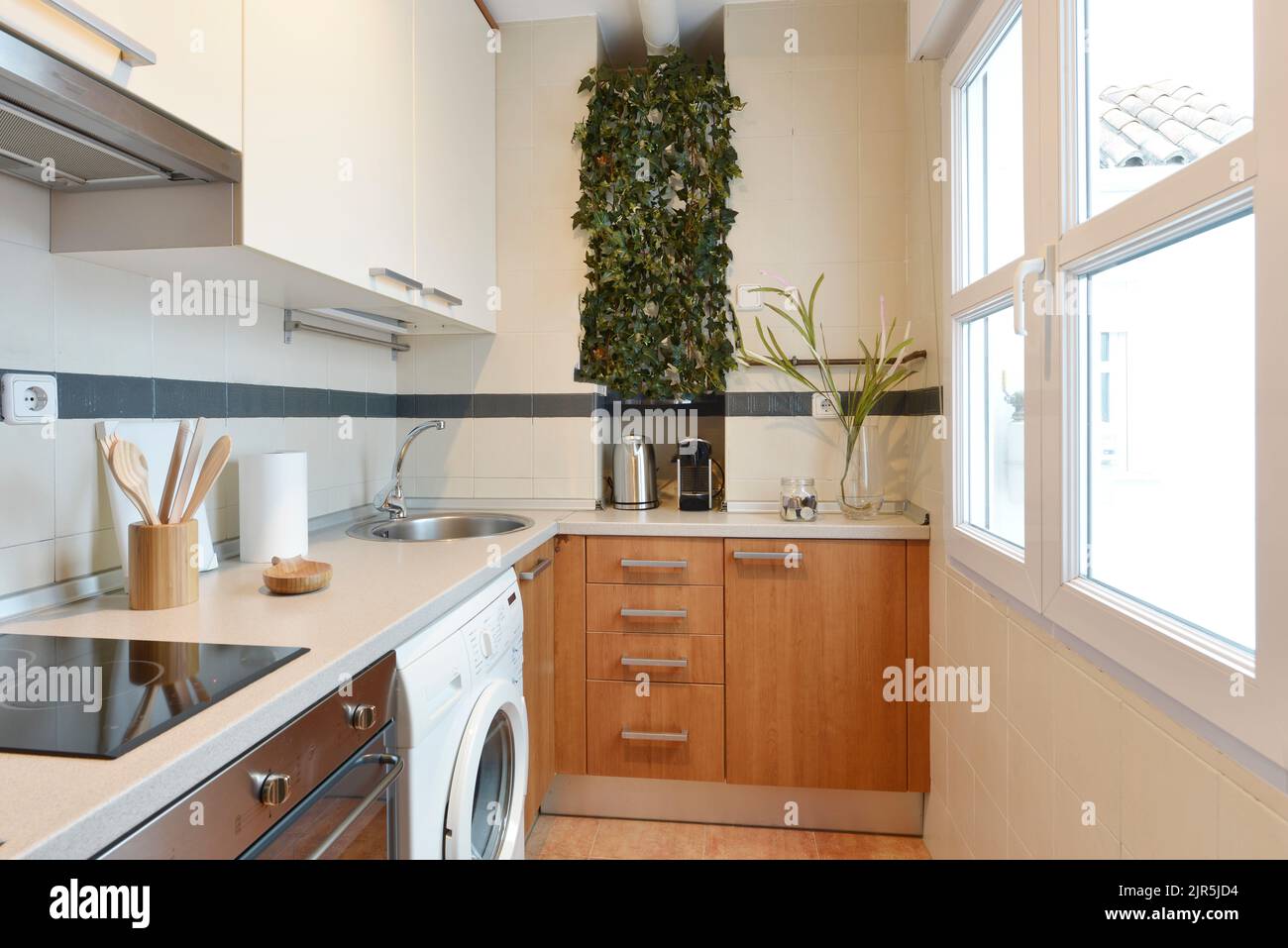 Kitchen with cherry wood base units, white wood wall units, gray stone ...