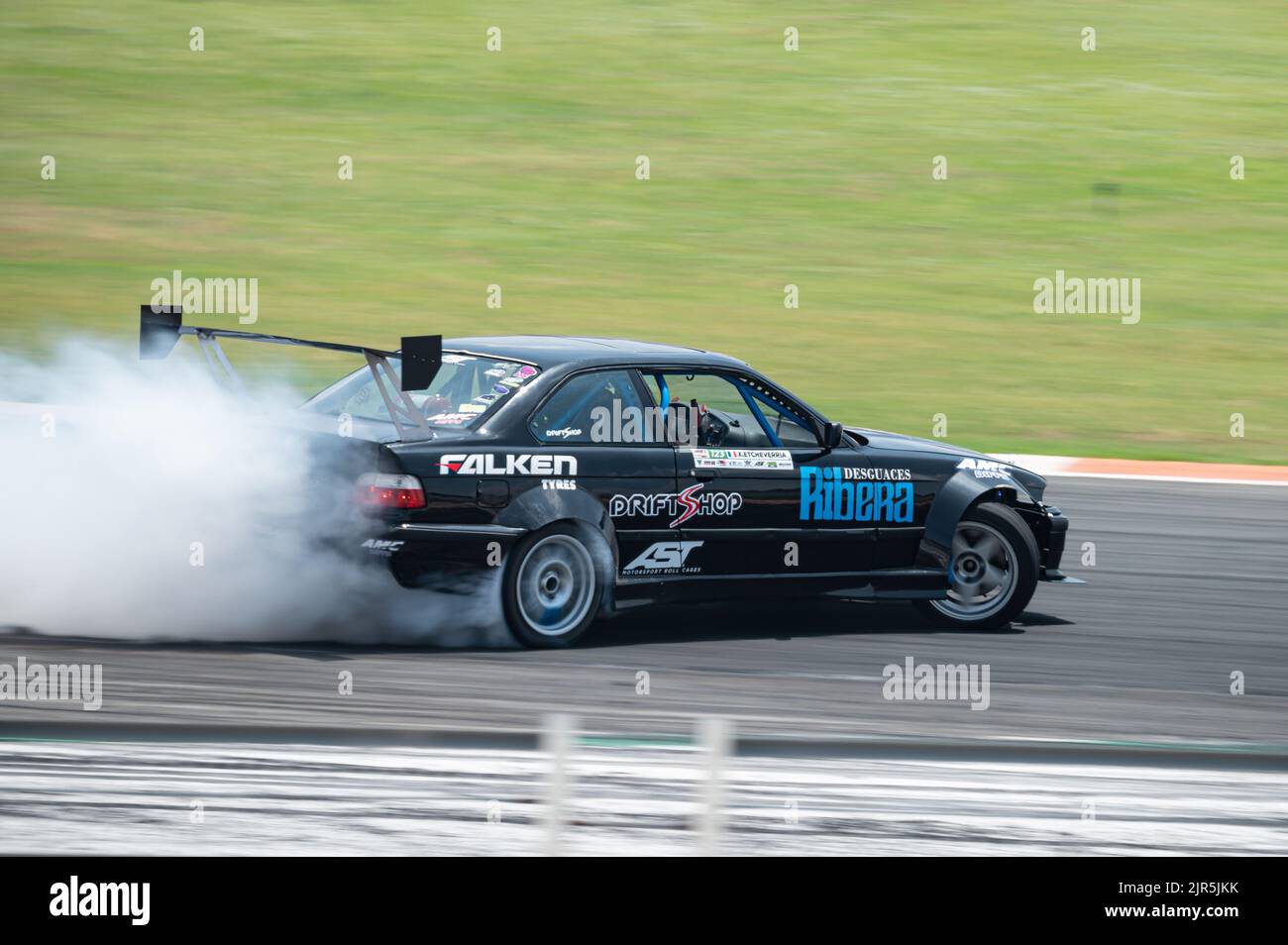 a-black-bmw-e36-producing-smoke-on-a-trail-for-a-drift-competition