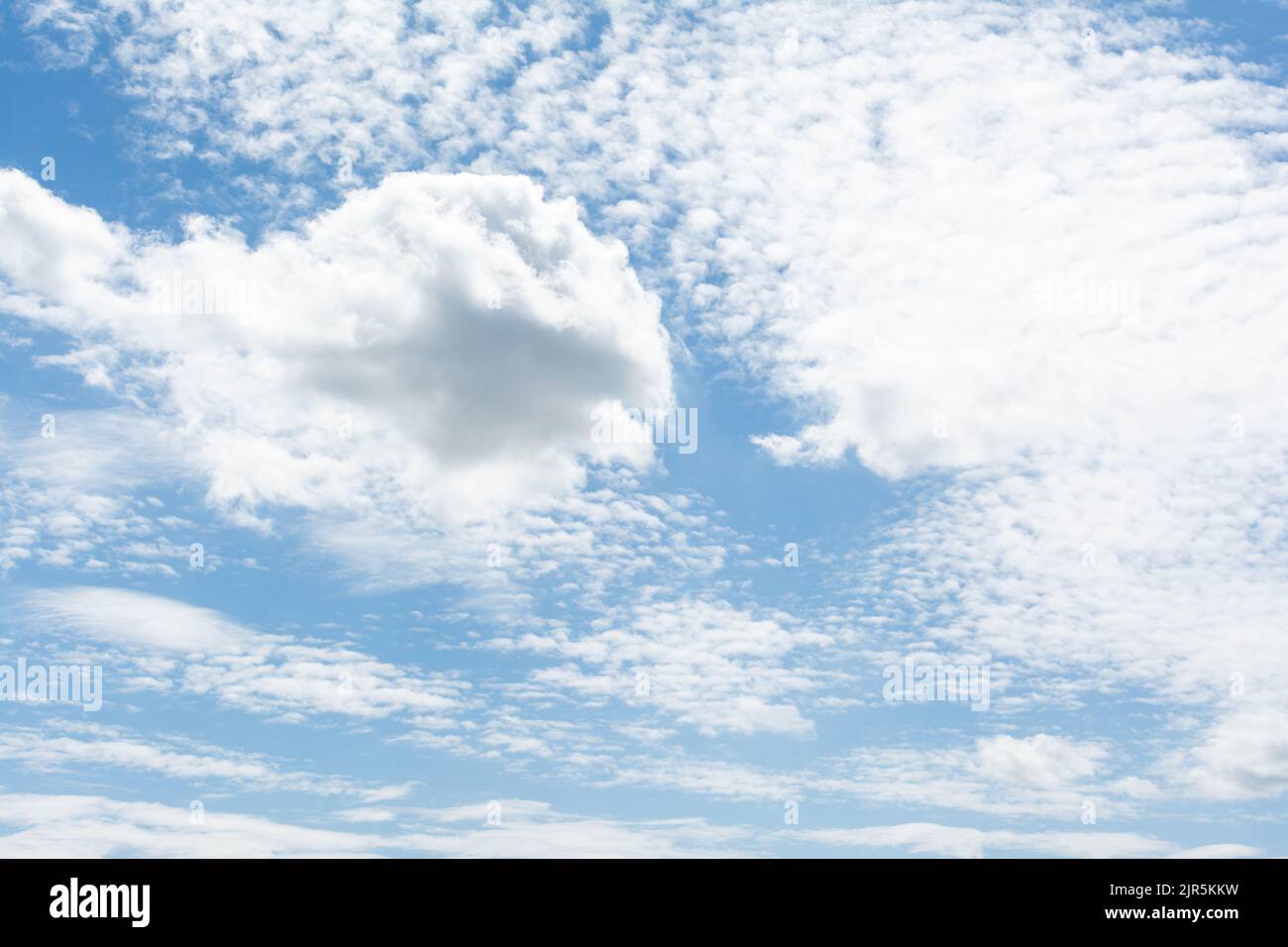 Blue sky with fluffy clouds Stock Photo - Alamy