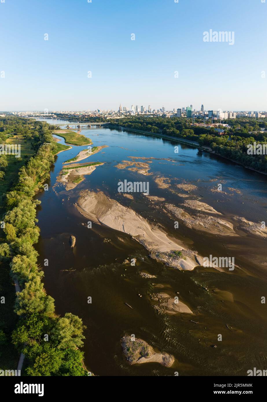 Low water level in Vistula river, effect of drought seen from the bird's eye perspective. City Warsaw in a distance. Stock Photo