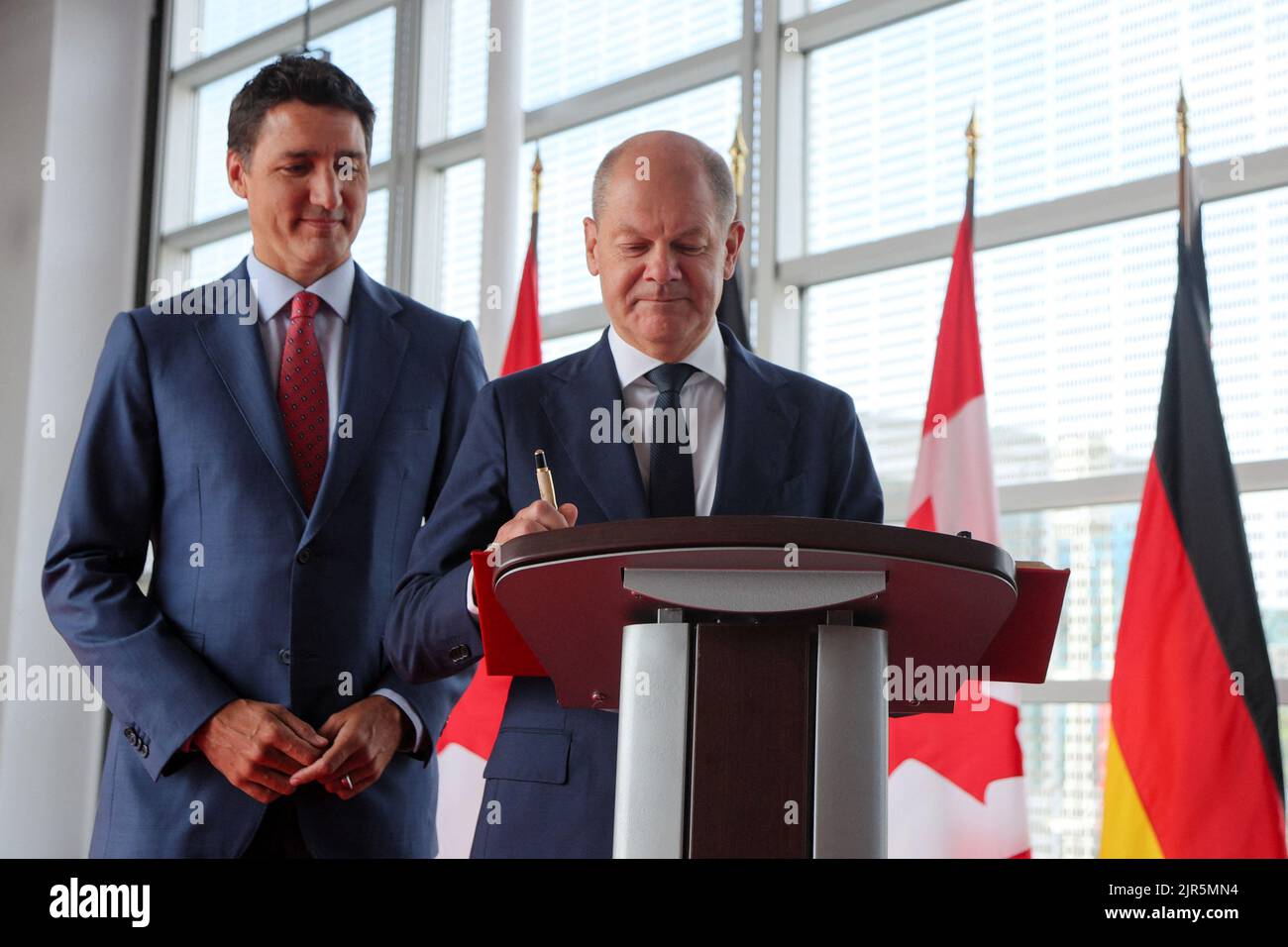 Germany's Chancellor Olaf Scholz signs the Golden Book of Canada as he is welcomed by Canada's Prime Minister Justin Trudeau at the Montreal Science Centre in Montreal, Quebec, Canada August 22, 2022.  REUTERS/Christinne Muschi Stock Photo