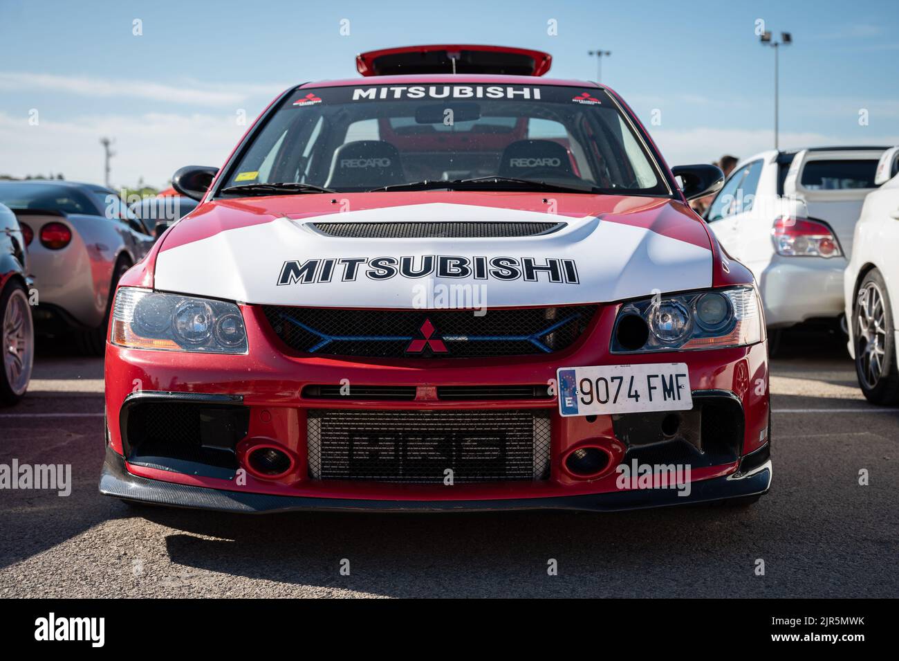 A red white Mitsubishi Lancer Evolution IX parked at an exhibition Stock Photo