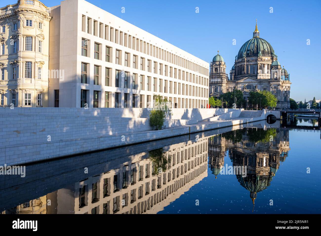 The rebuilt Berlin City Palace with the Cathedral reflected in the river Spree Stock Photo