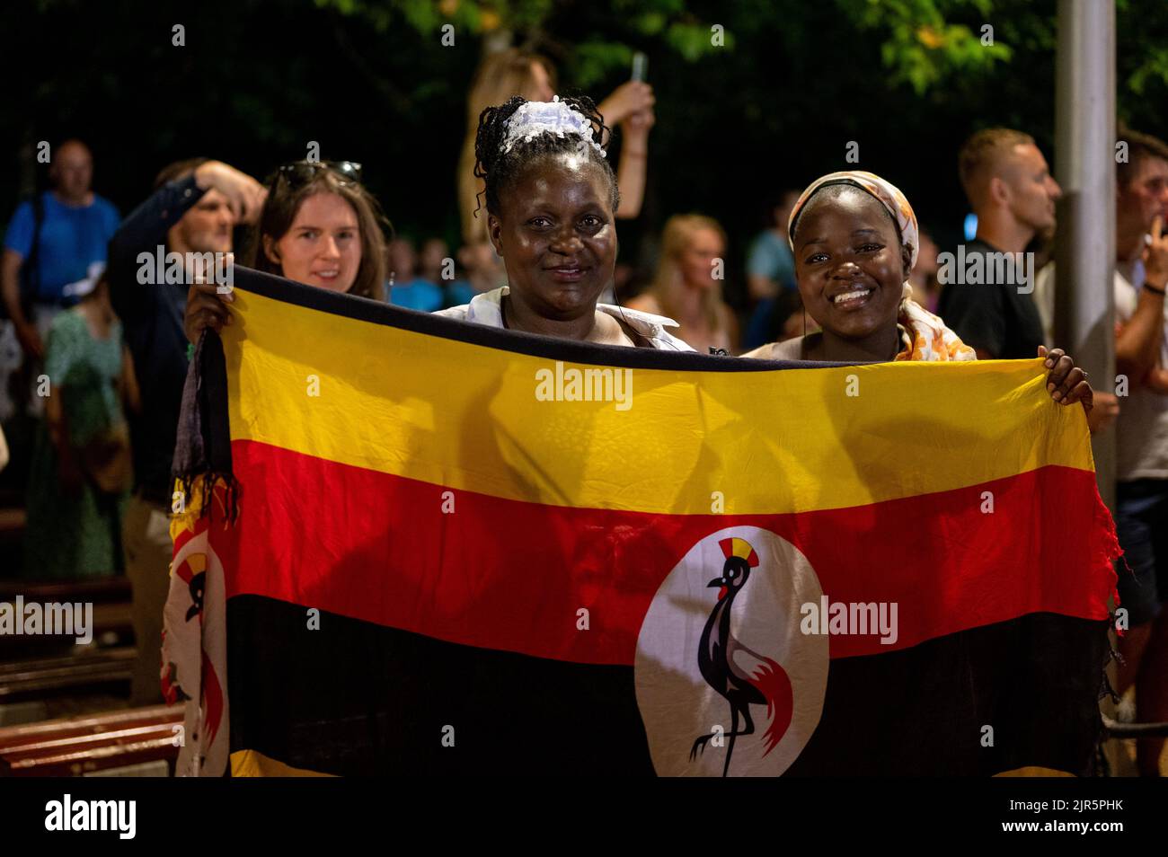 Women from Uganda holding Ugandan flag at the Mladifest, the youth festival in Medjugorje, Bosnia and Herzegovina. 2021/08/05. Stock Photo