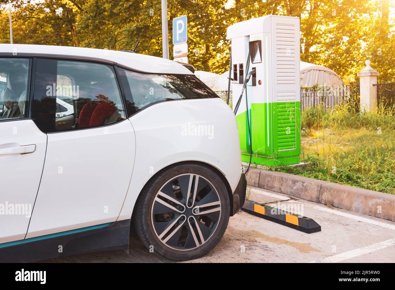 Charging a car battery in a city parking lot Stock Photo Alamy