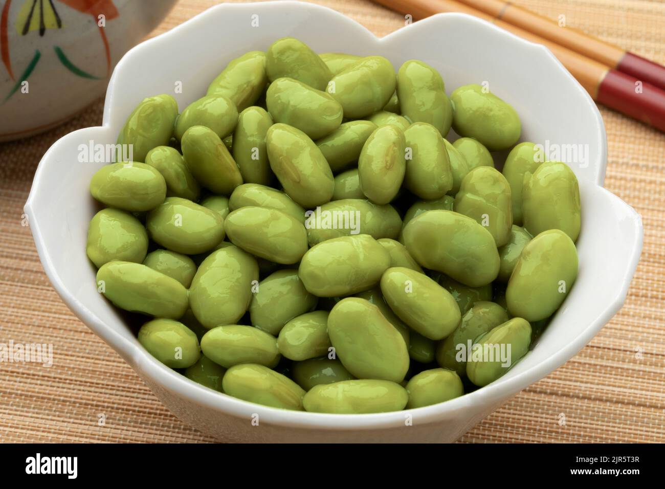 Bowl with preserved healthy green edamame beans close up Stock Photo