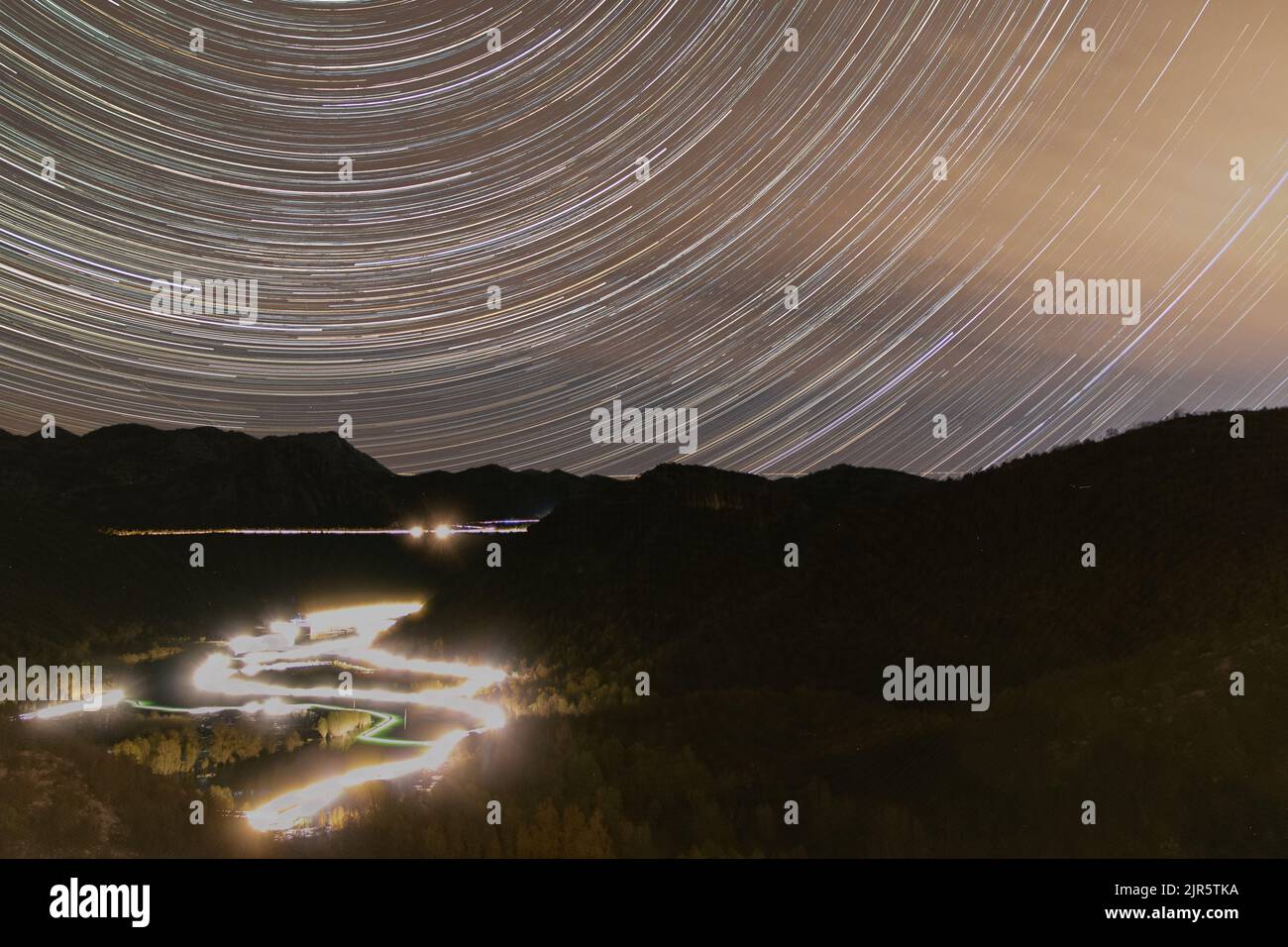 Star trail of night fishermen on river towards Shkodra Lake Montenegro Stock Photo