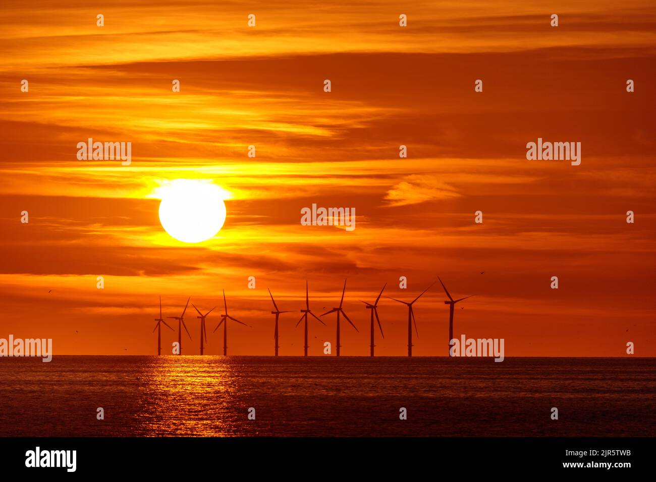 Sunset over Gwynt-y-Môr offshore wind farm, North Wales coast Stock Photo
