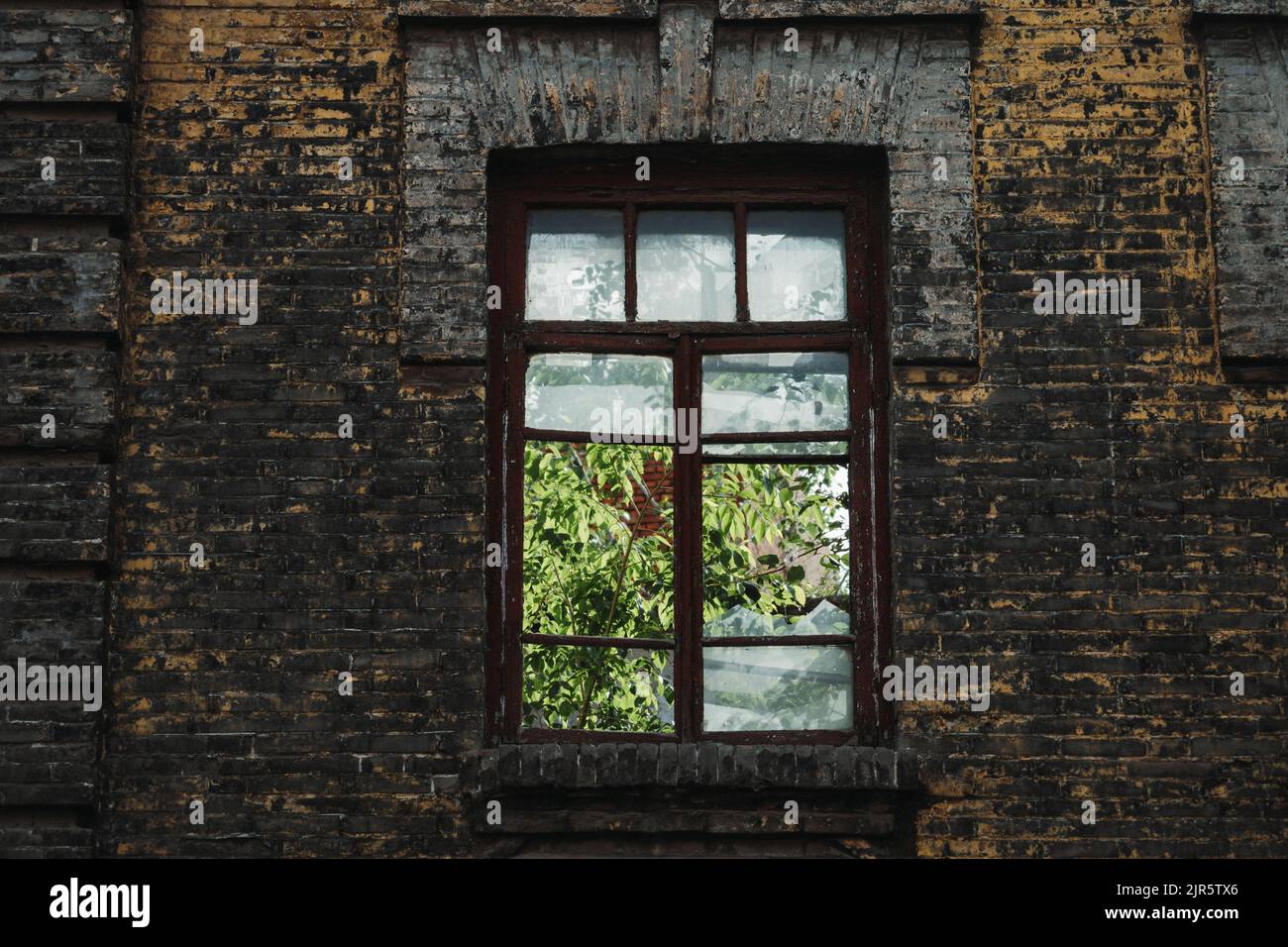 The old brick wall of an abandoned building with the window towards the ...