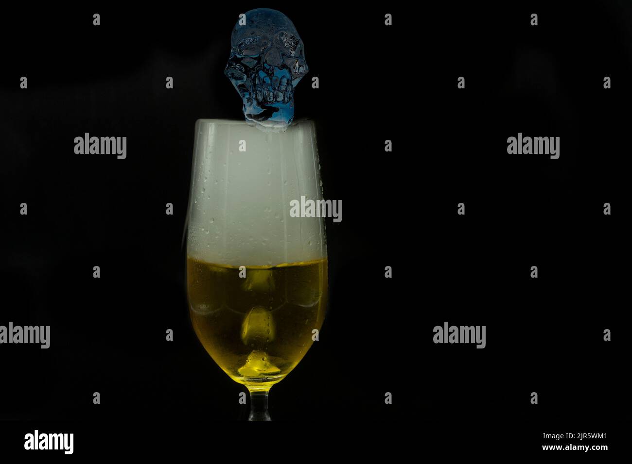 ice human skull decorating glass for extra cold beer steaming with dry ice method for Halloween party mystery nightmare presentation Stock Photo