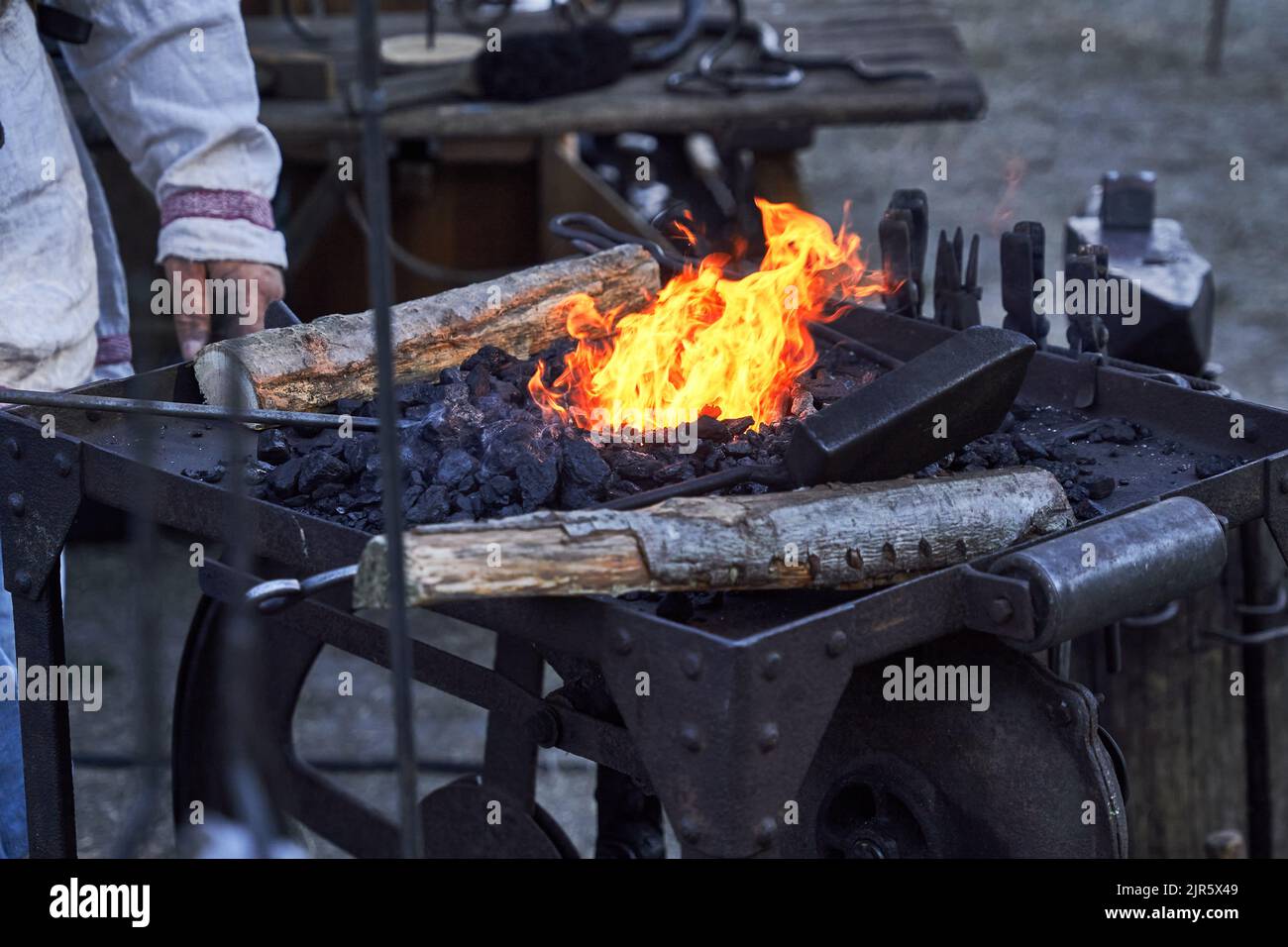 Blazing bright fire in the iron basin of the blacksmith filled
