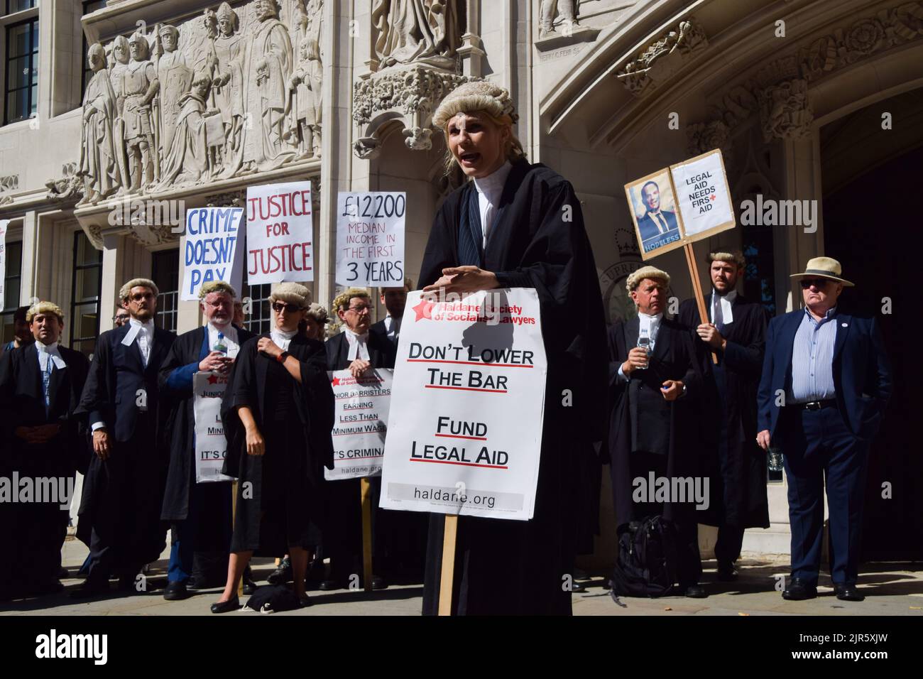 London, UK. 11th July 2022. A barrister addresses the protesters outside the court. Criminal barristers gathered outside the Supreme Court as the strikes over pay and legal aid fees enter their third week. Stock Photo