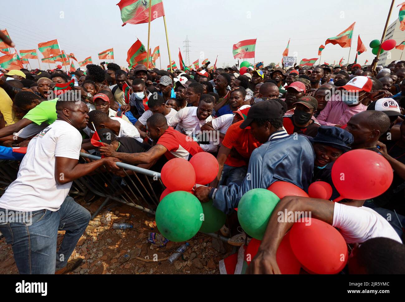A man attempts to control supporters of Angola's main opposition party UNITA, as they attend the party's final rally at Cazenga, outside the capital Luanda in Angola, August 22, 2022.REUTERS/Siphiwe Sibeko Stock Photo