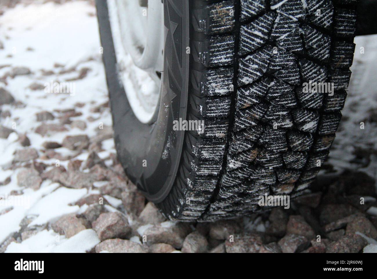 Sipes, grooves and treads of winter tire at off road driving Stock Photo