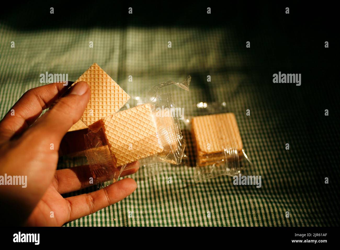 Hand holding square wafer biscuits Stock Photo