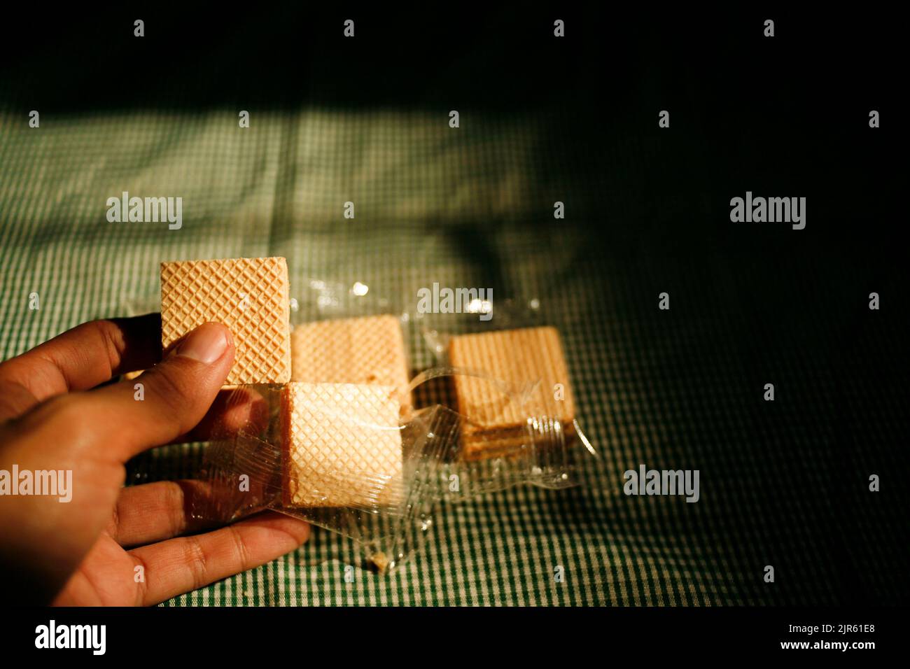 Hand holding square wafer biscuits Stock Photo