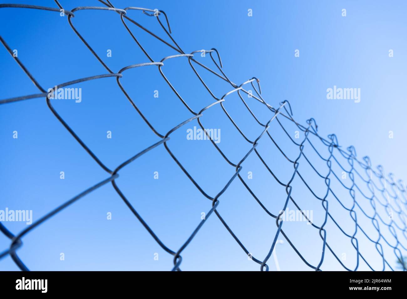 cyclone fence detail with blue sky Stock Photo Alamy