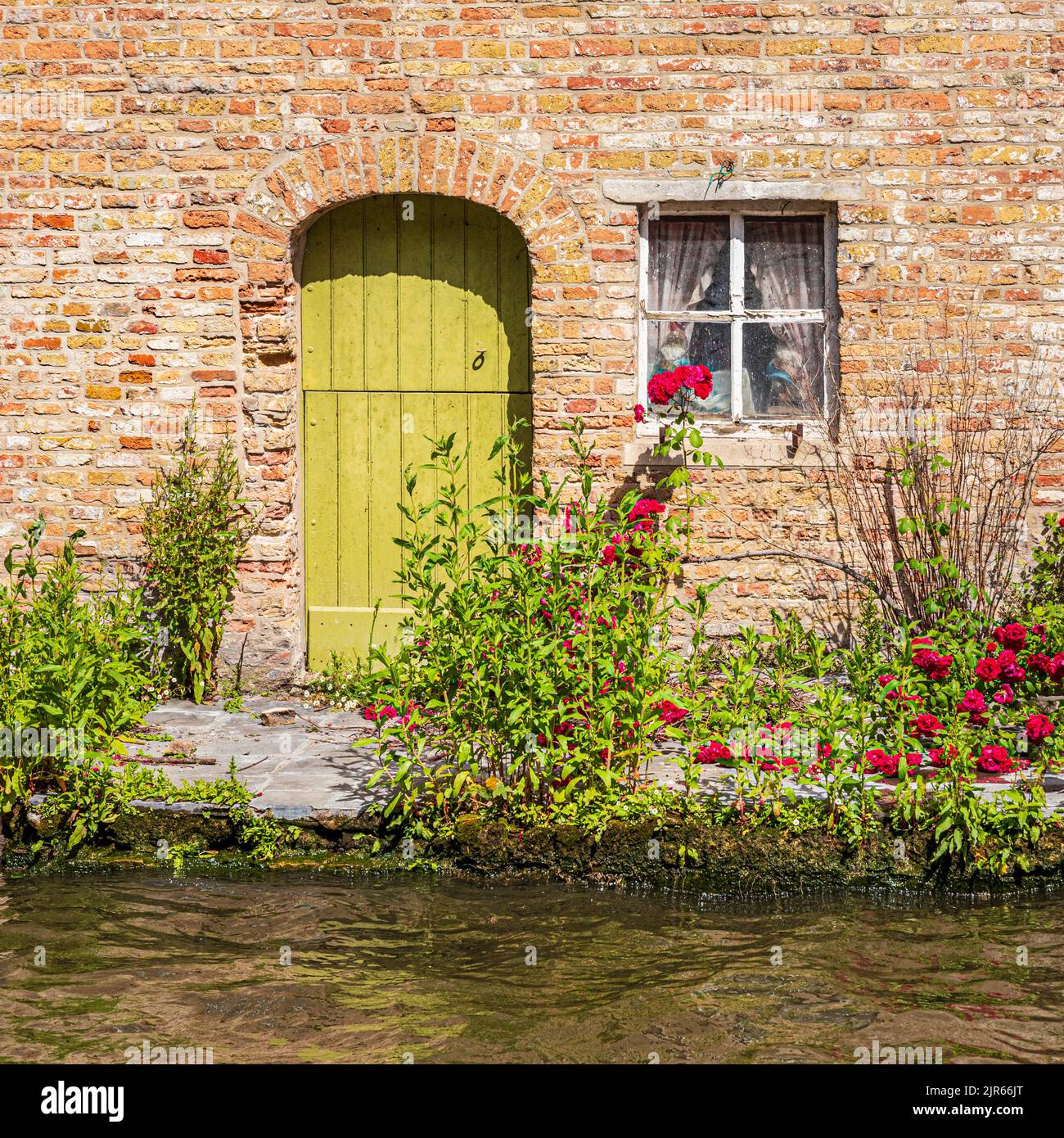 An old building beside the canal in Bruges, Belgium Stock Photo