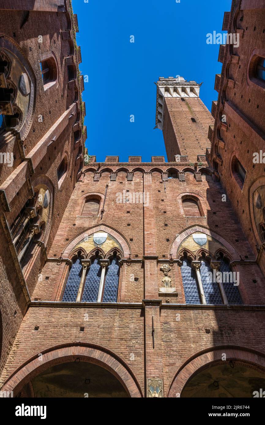 View looking up from interior of Palazzo Pubblico to Torr del Mangia bell tower in Siena, Tuscany, Italy Stock Photo