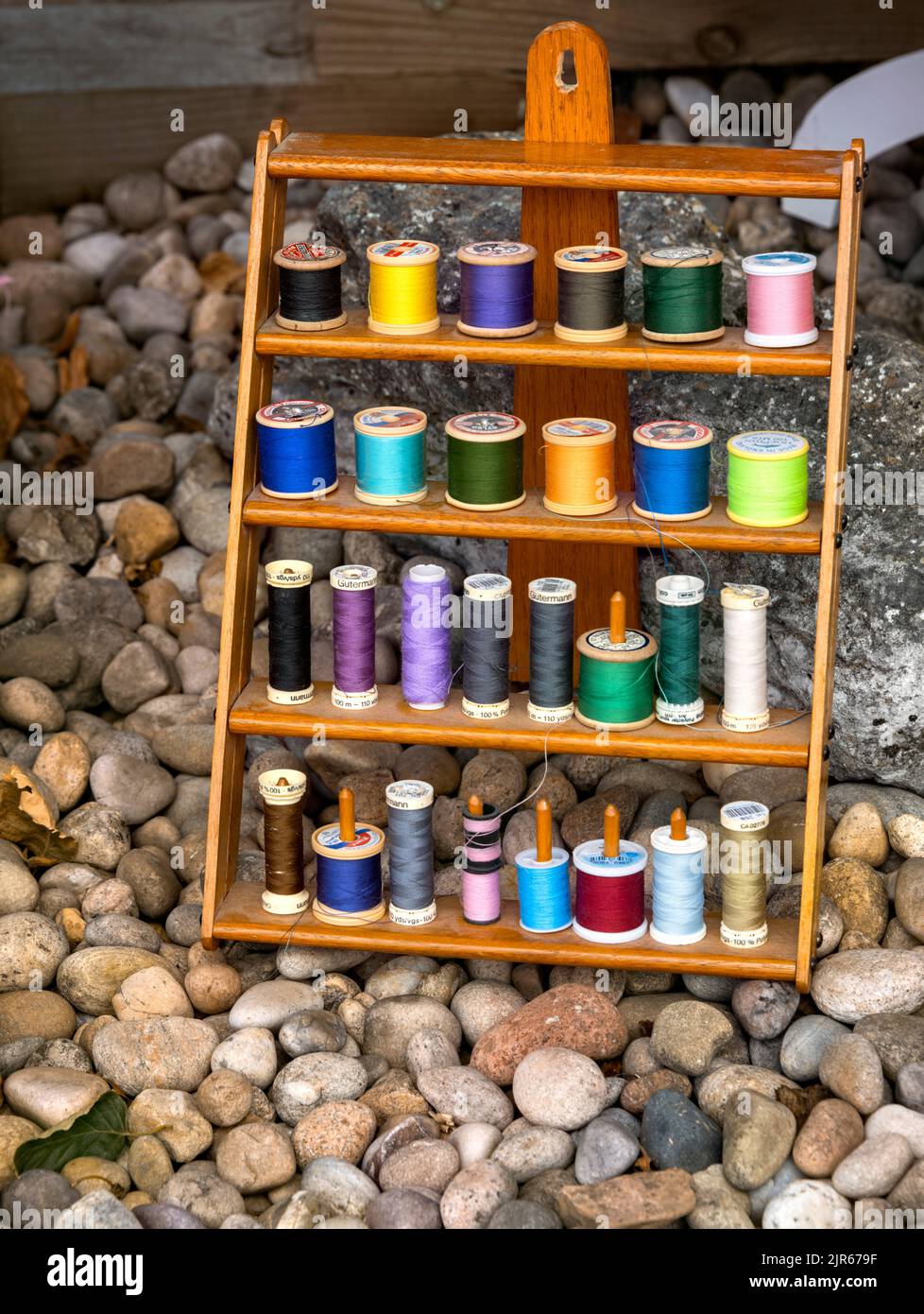 Display of colourful Gutermann and other cotton threads on wooden display rack, Flamstead, Hertfordshire UK Stock Photo