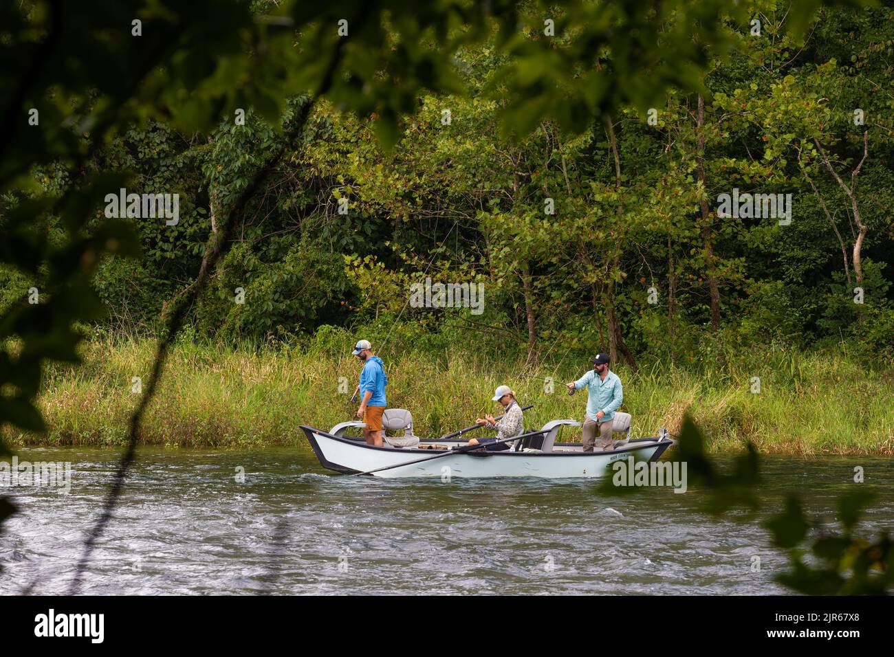 Bristol, Tennessee, USA - Autust 16, 2022:  Three men fishing from an anchored boat on the South Holston River near Bristol, Tennessee Stock Photo