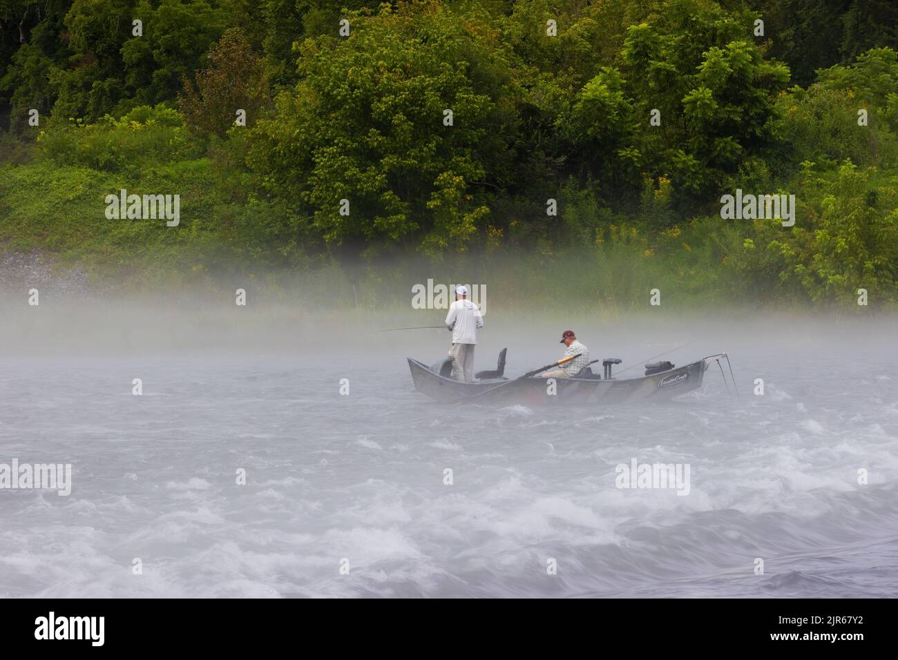Bristol, Tennessee, USA - Autust 16, 2022:  Two mn fishing from an anchored boat on the South Holston River near Bristol, Tennessee Stock Photo