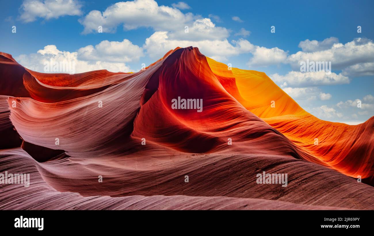 The orange wavy sandstones of Upper Antelope Canyon against sunny blue ...