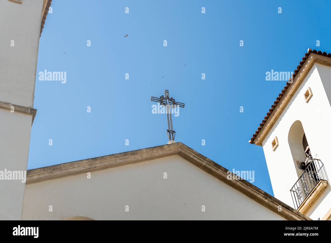 The metal cross over the Church of St. Mary Magdalene (Iglesia Santa Maria Magdalena), Alicante, Spain Stock Photo