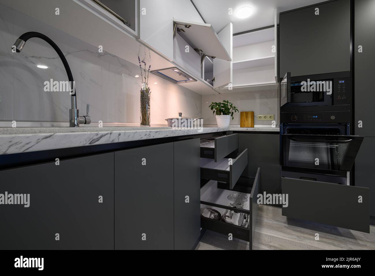 Modern simple trendy dark grey and white kitchen Stock Photo