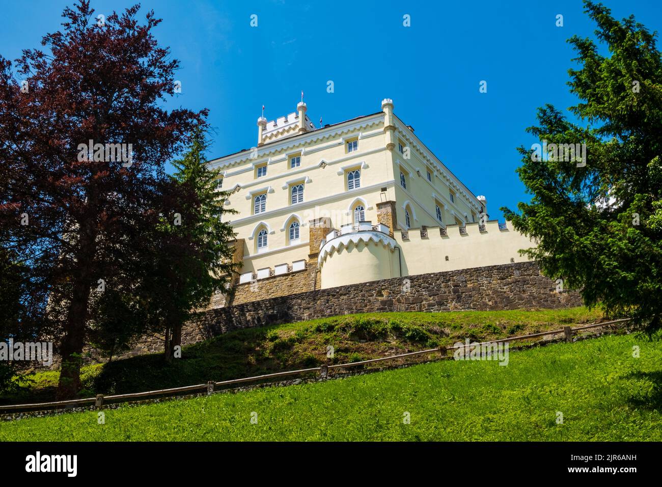 Sweeping view looking up at the pastel colors of Trakošćan Castle in Northern Croatia Stock Photo