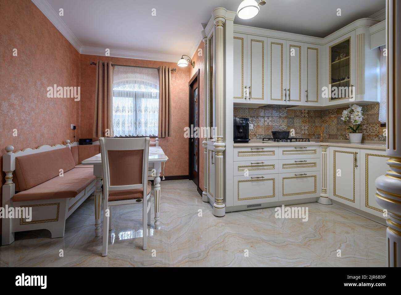 White classic cozy kitchen and dining room in city house Stock Photo