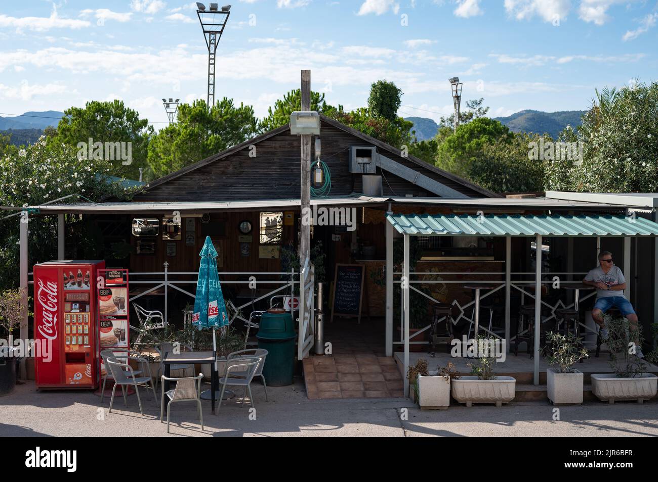 An exterior view of an old roadside bar in the mountainous area in sunny weather Stock Photo