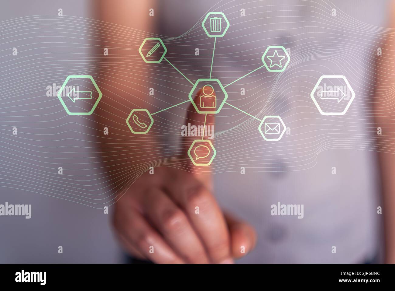 Woman pressing with her finger on the contact icons of a virtual screen Stock Photo