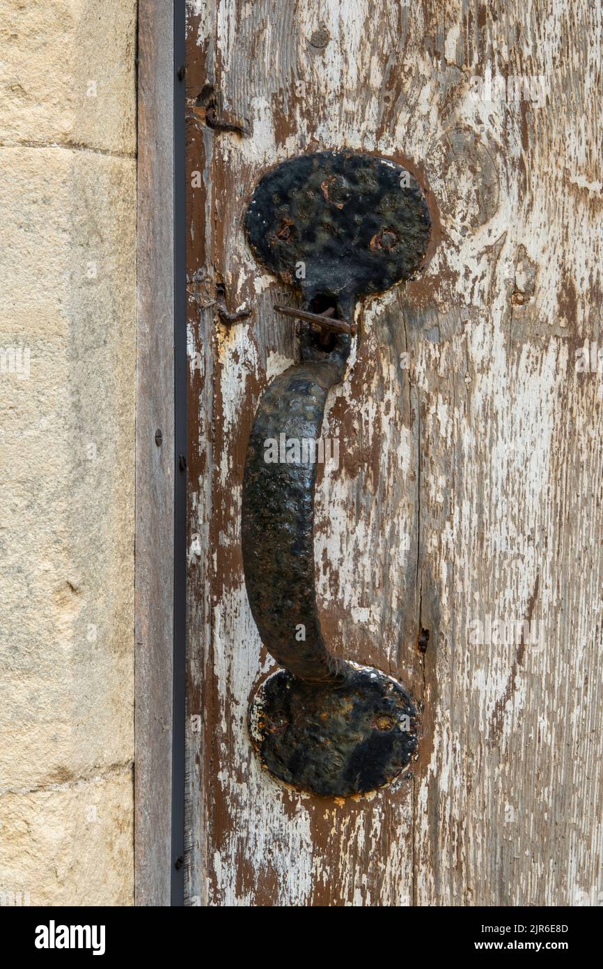 Single thumb action antique door latch with handle Stock Photo