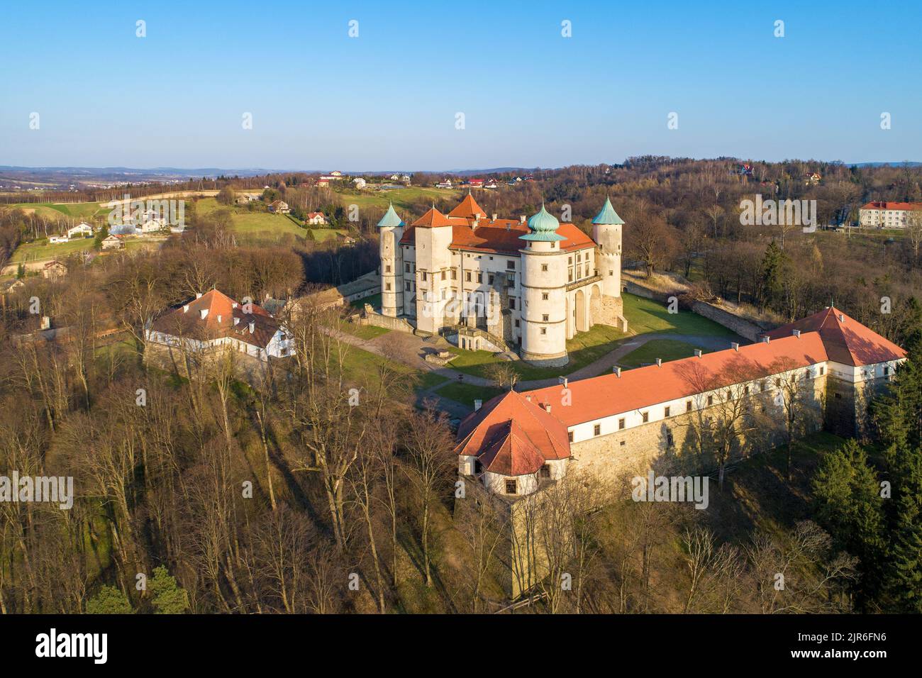 Poland. Renaissance, partly Baroque Castle on the hill in Nowy Wiśnicz. Presently owned by Polish state. Aerial view in spring. Sunset light Stock Photo