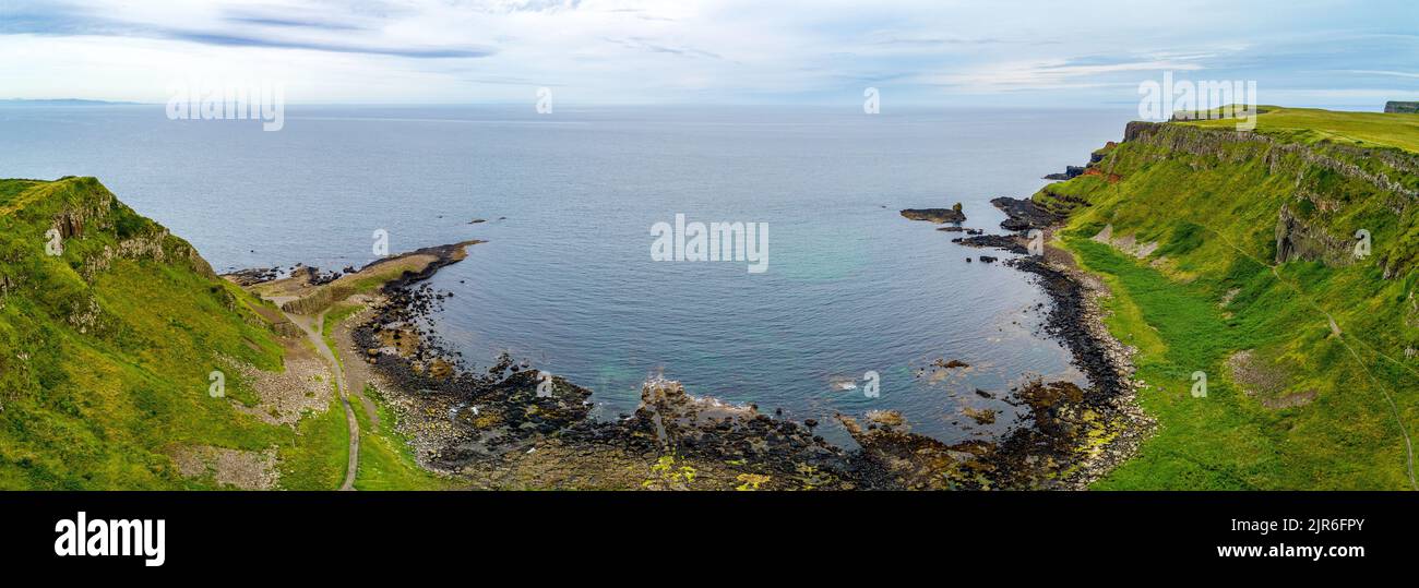 Panorama of Atlantic coastline in Northern Ireland with Giant’s Causeway, unique natural geological formations of volcanic basalt rocks, resembling co Stock Photo