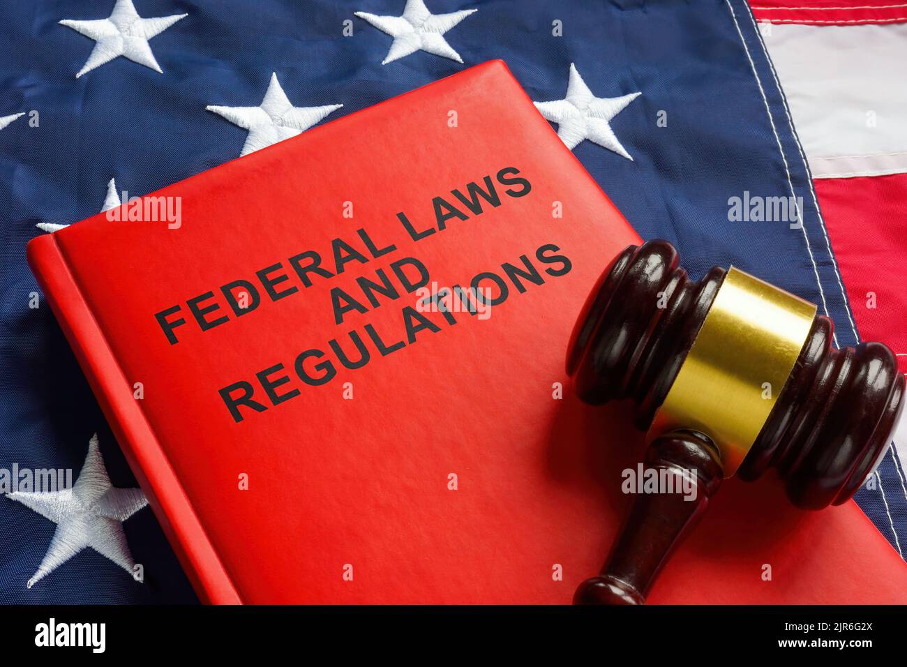 Federal laws and regulations book and gavel on the flag. Stock Photo