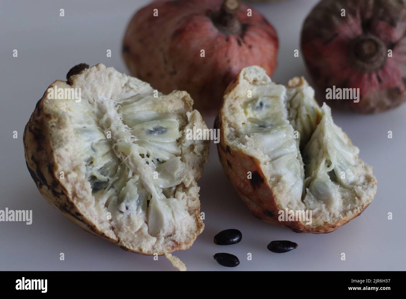 Slices of Red Custard Apple Fruit or Annona Reticulata Bullocks Heart. A fruit which is vary in shape. When ripe, fruit is brown or yellowish, with re Stock Photo