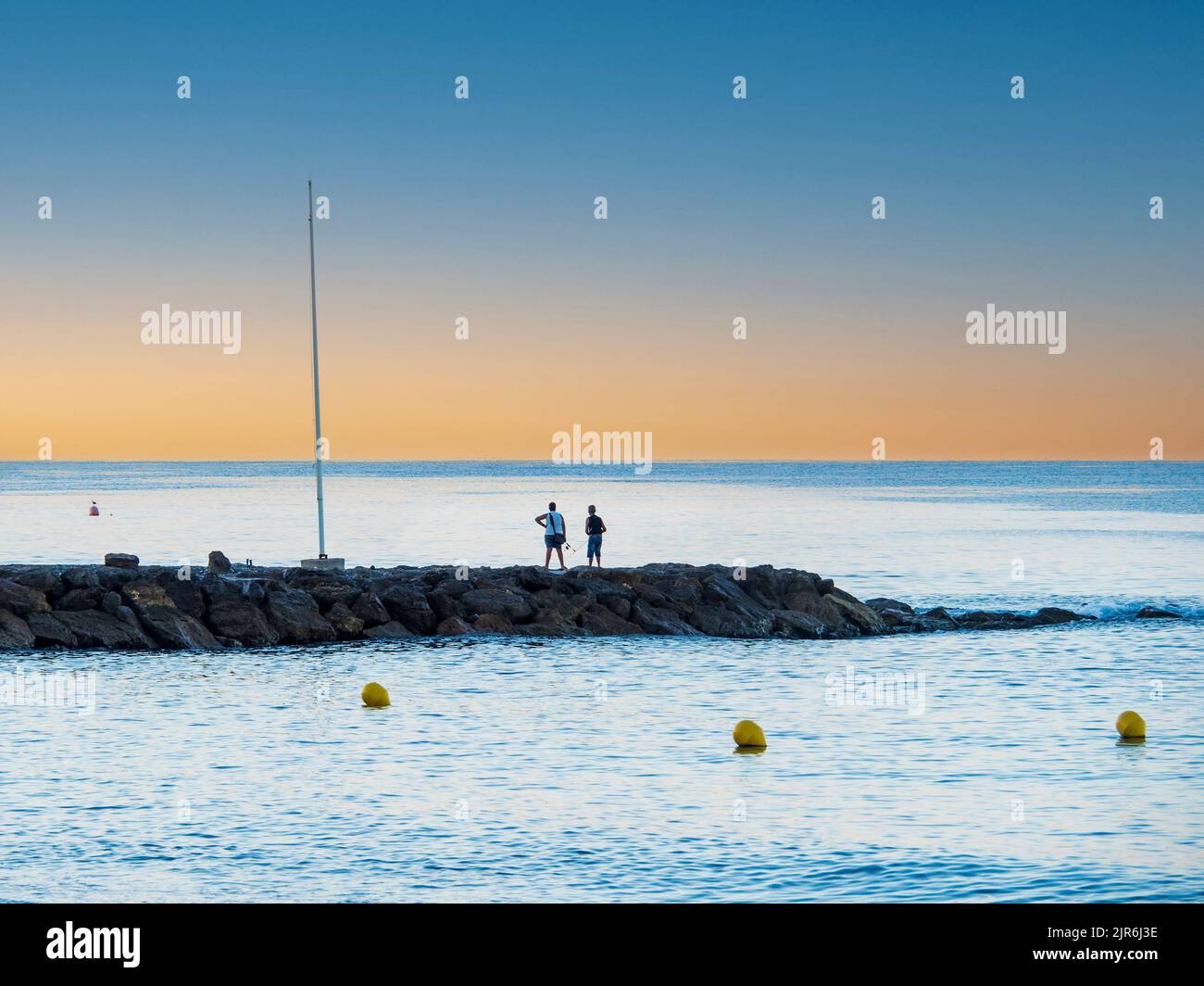 Fishermen on a quay on the coast of Malaga Stock Photo