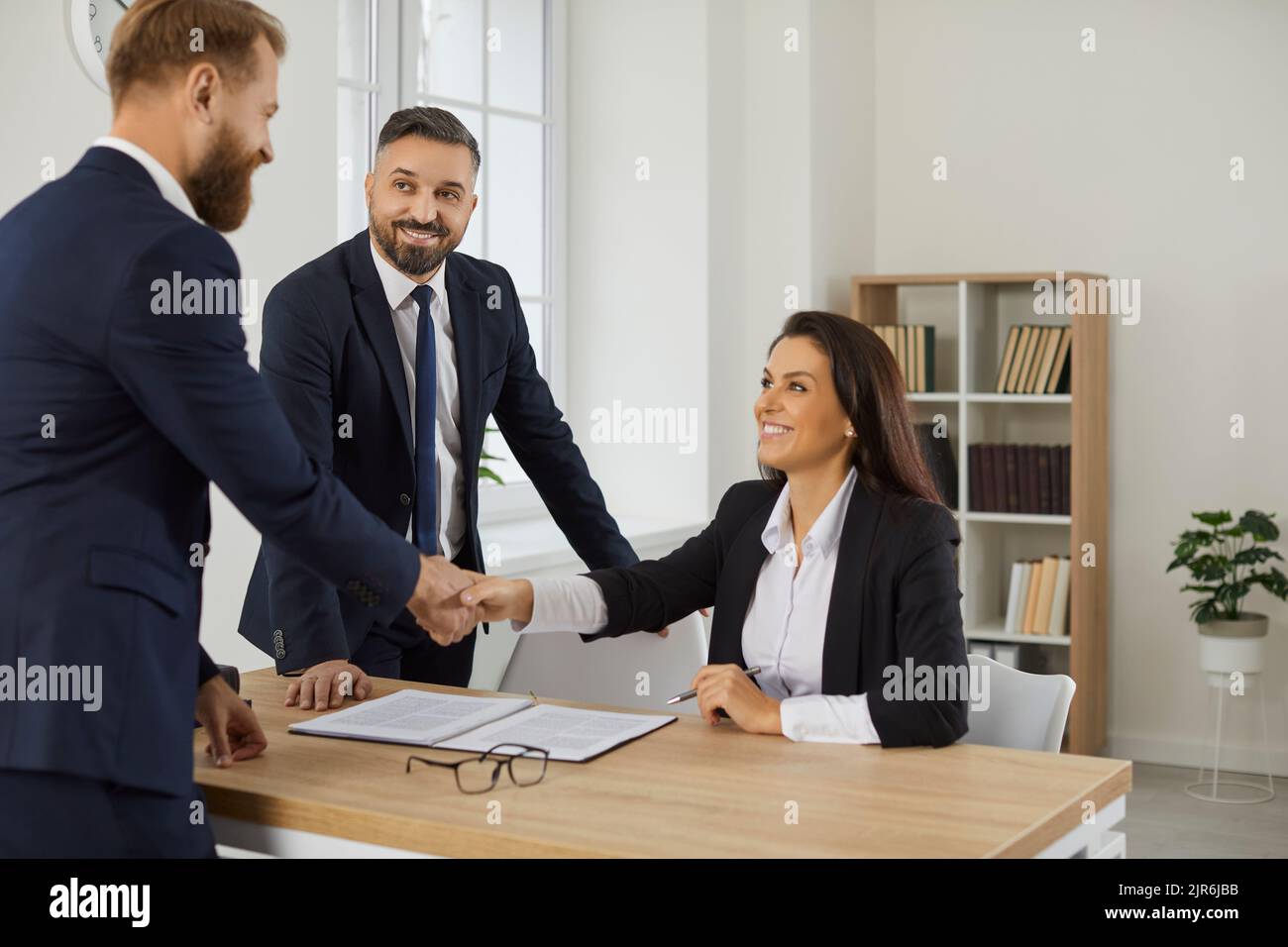 Smiling diverse businesspeople handshake get acquainted Stock Photo