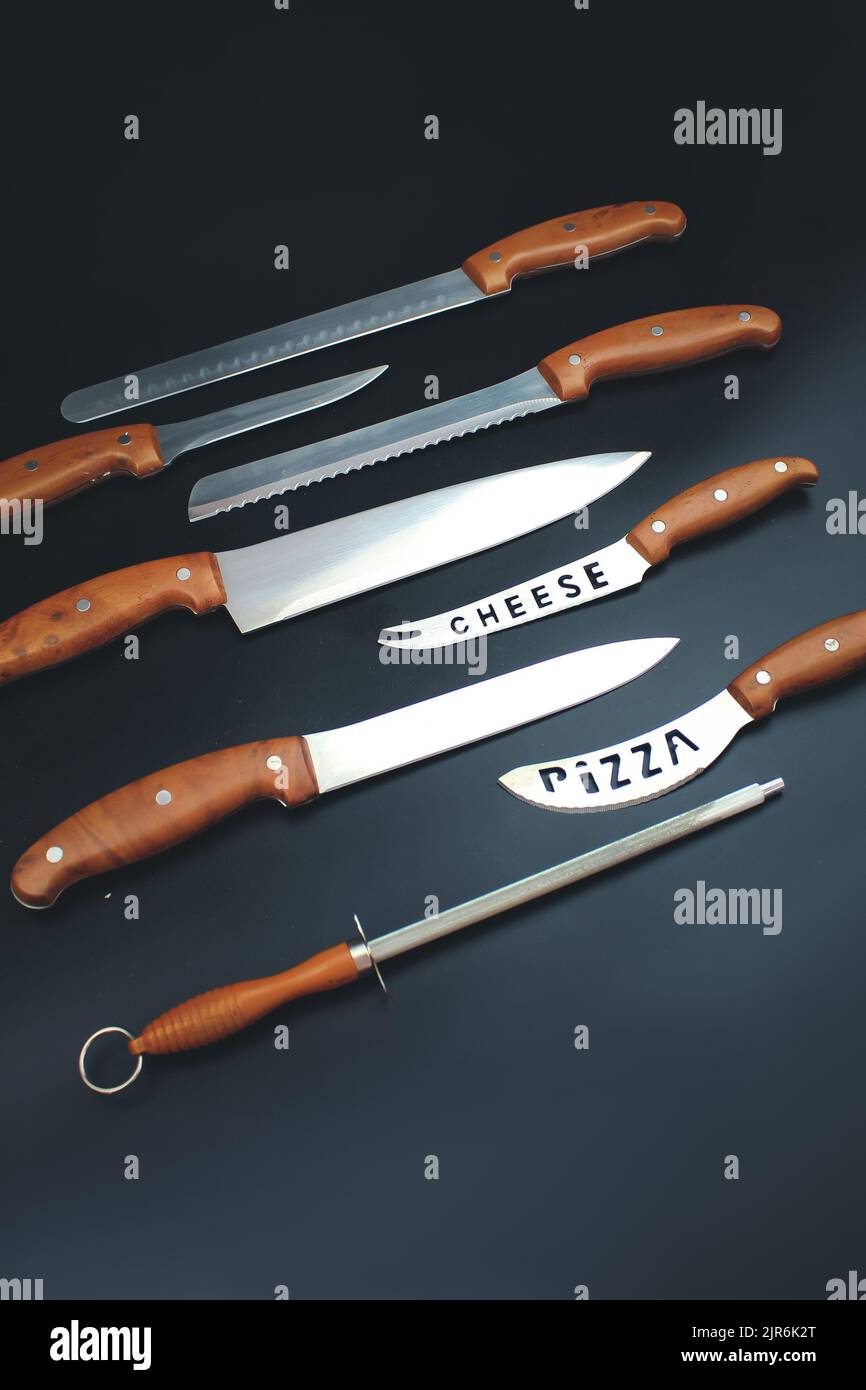 Set of Kitchen knives on grey background. Quality Kitchen Knives. Stock Photo