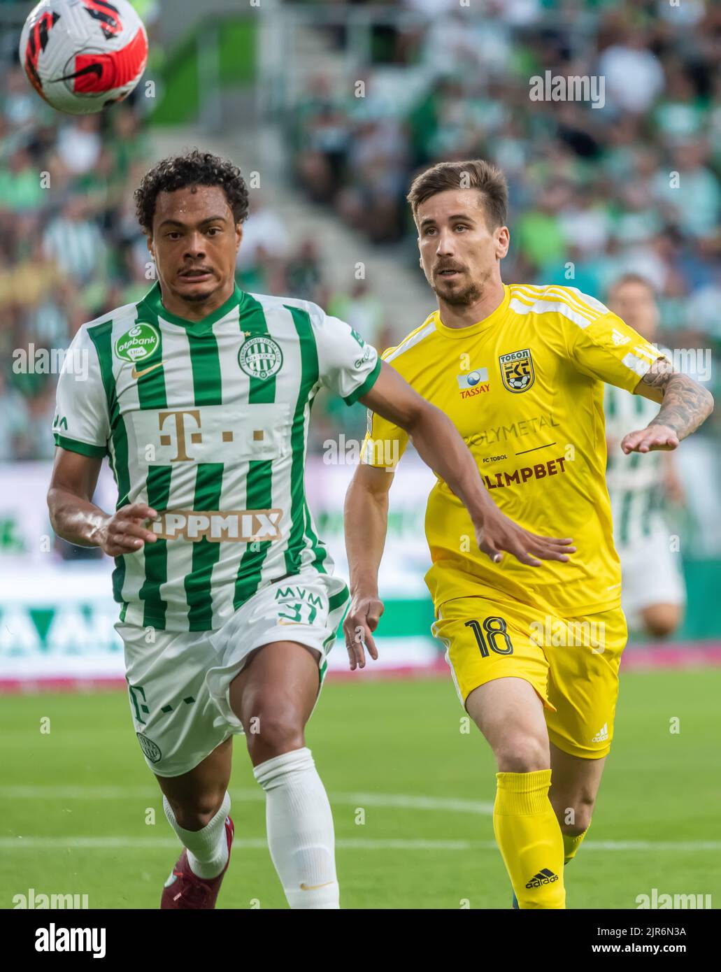 BUDAPEST, HUNGARY - JULY 13: Aleksa Amanovic of FC Tobol challenges  Kristoffer Zachariassen of Ferencvarosi TC during the UEFA Champions League  2022/23 First Qualifying Round Second Leg match between Ferencvarosi TC and